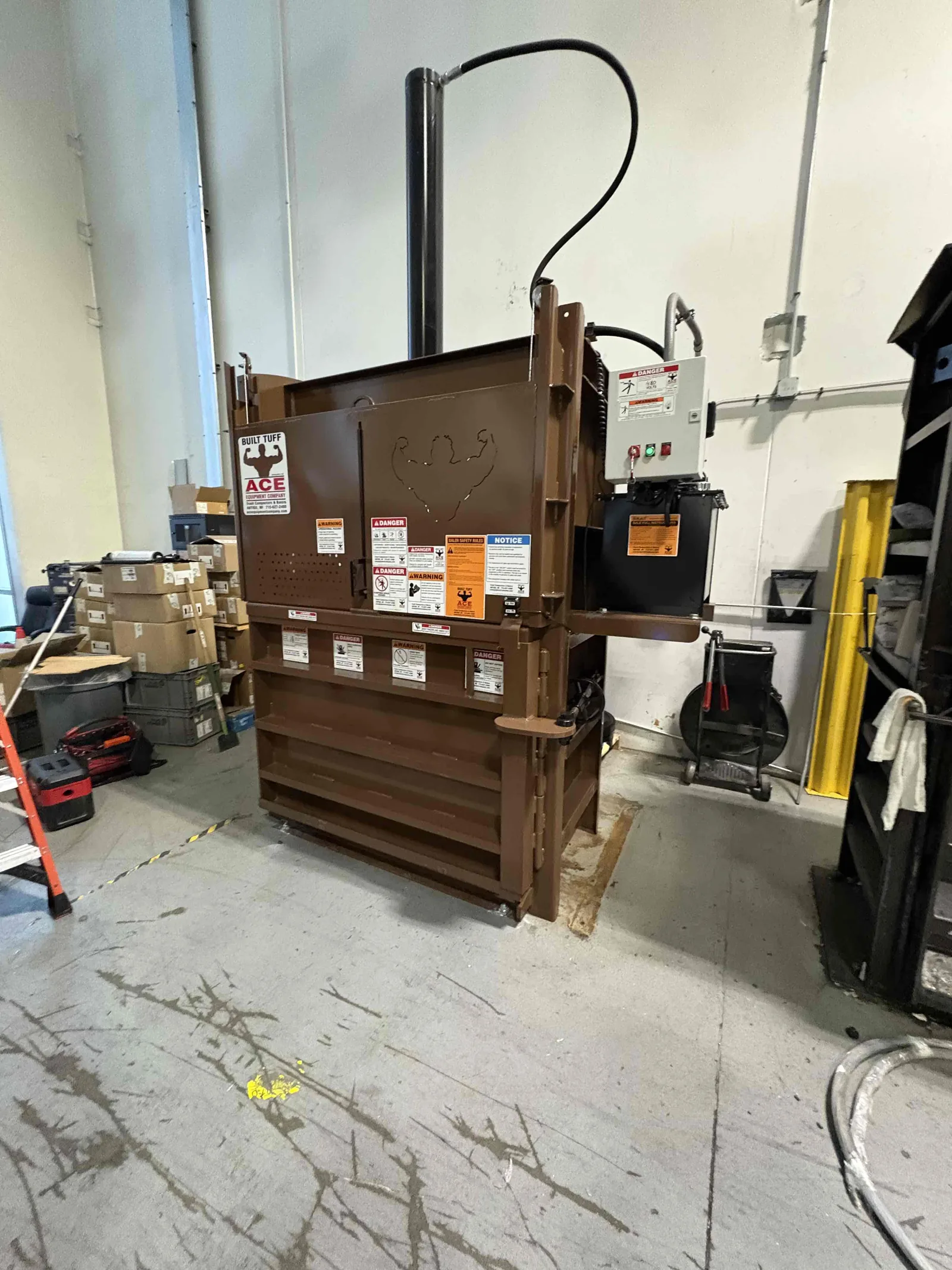 A vertical baler installed in a warehouse