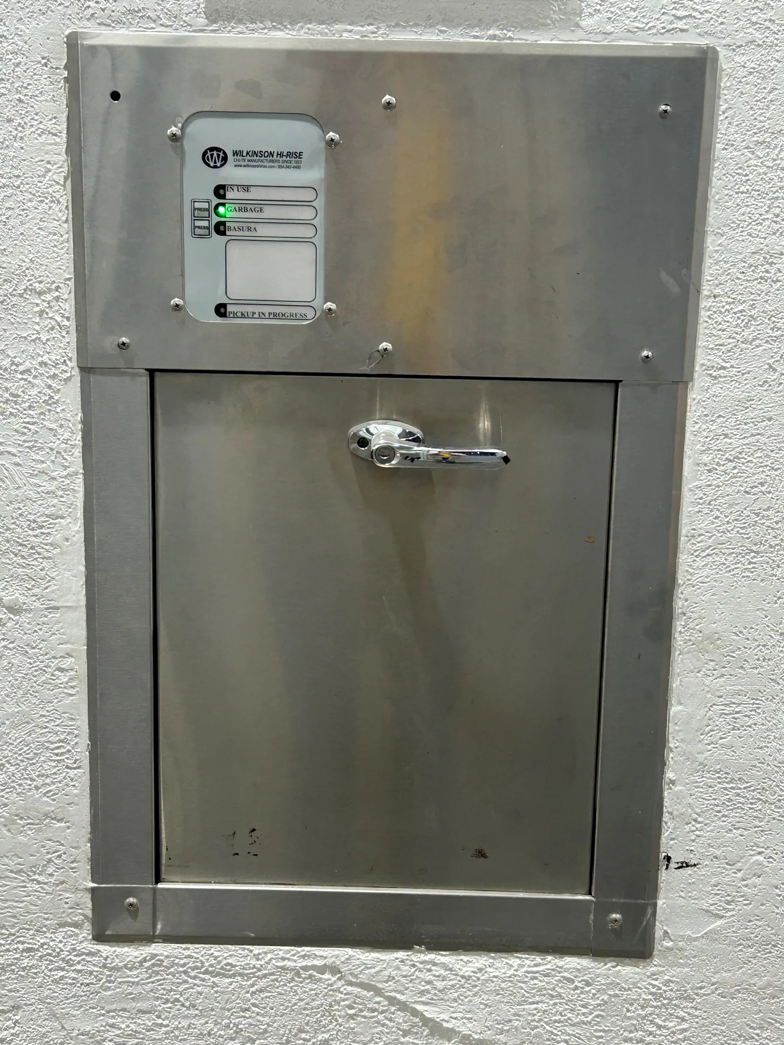 A trash chute door with electronic controls