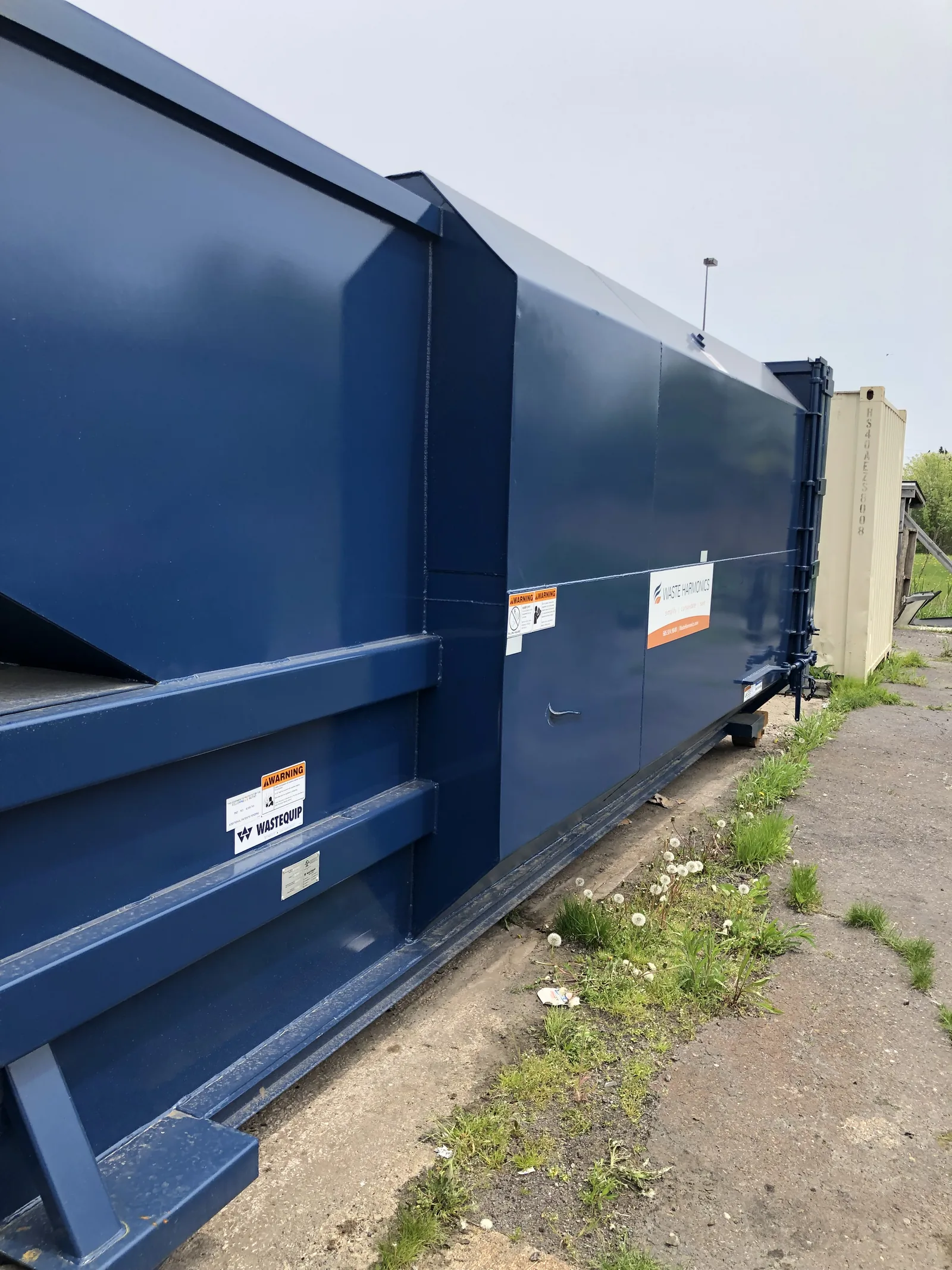 A blue compactor unit
