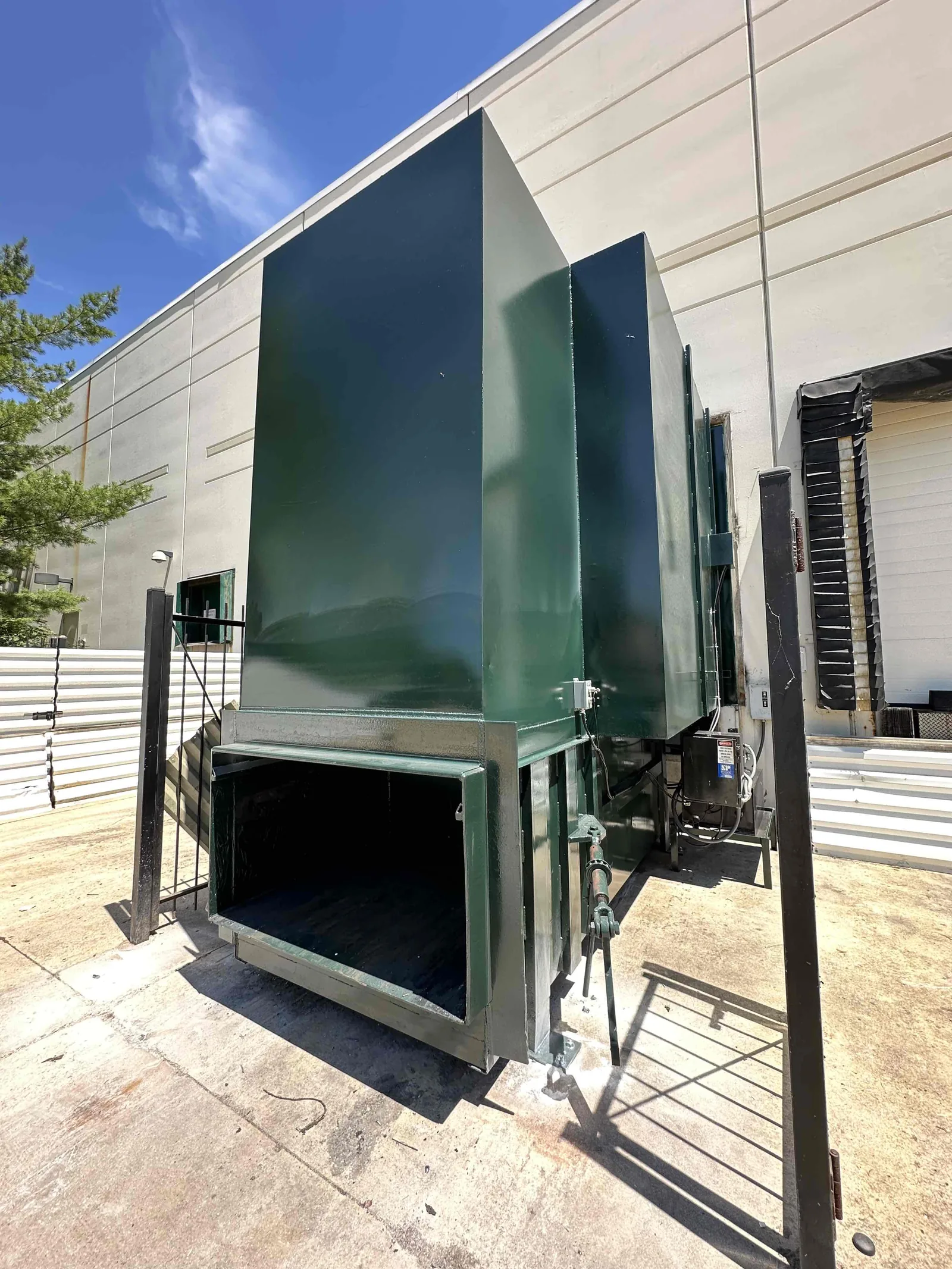 A green compactor installed indoors