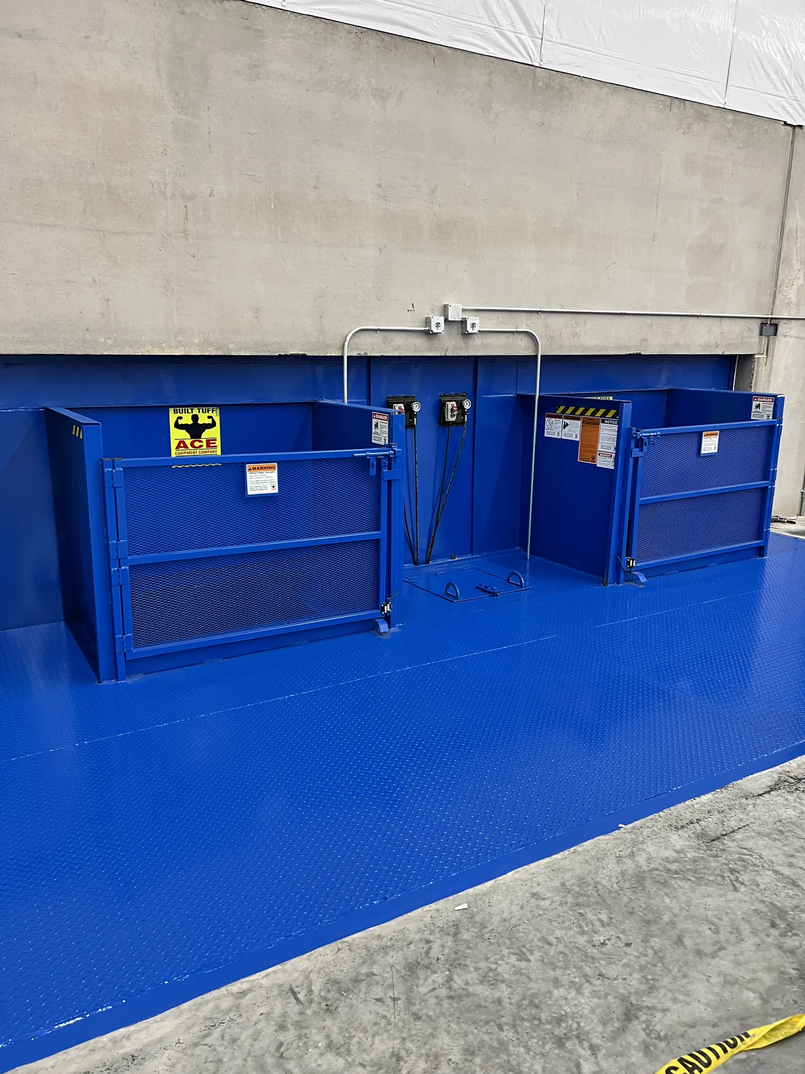 Blue compactor containers ready for installation