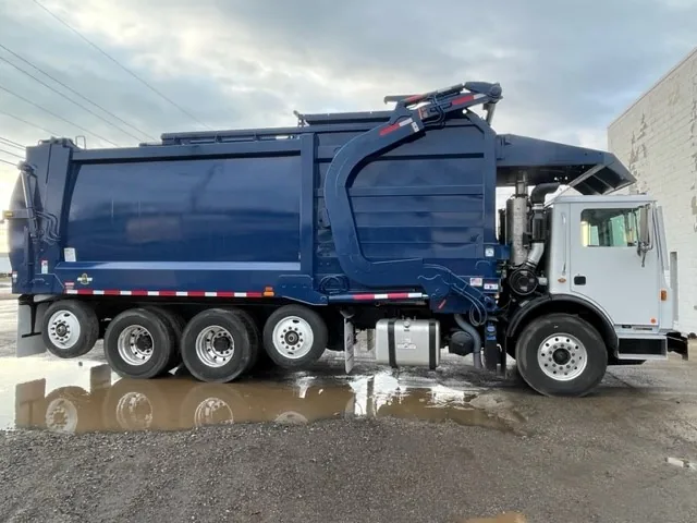 An MCS Midwest front-loading refuse collection truck