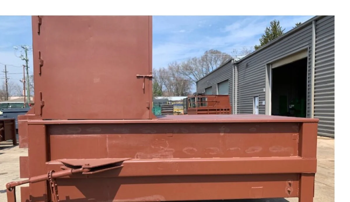 A used 2yd stationary compactor with left side hopper